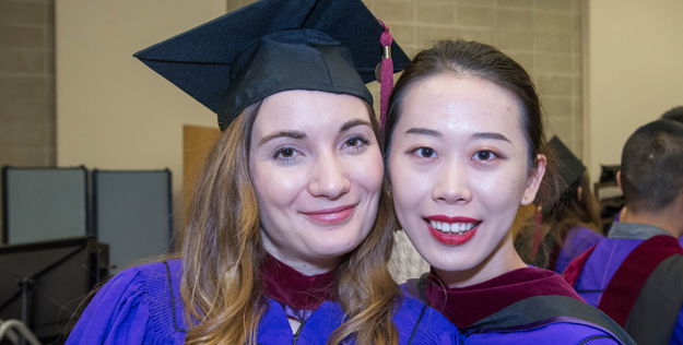 Students in their graduation regalia. 